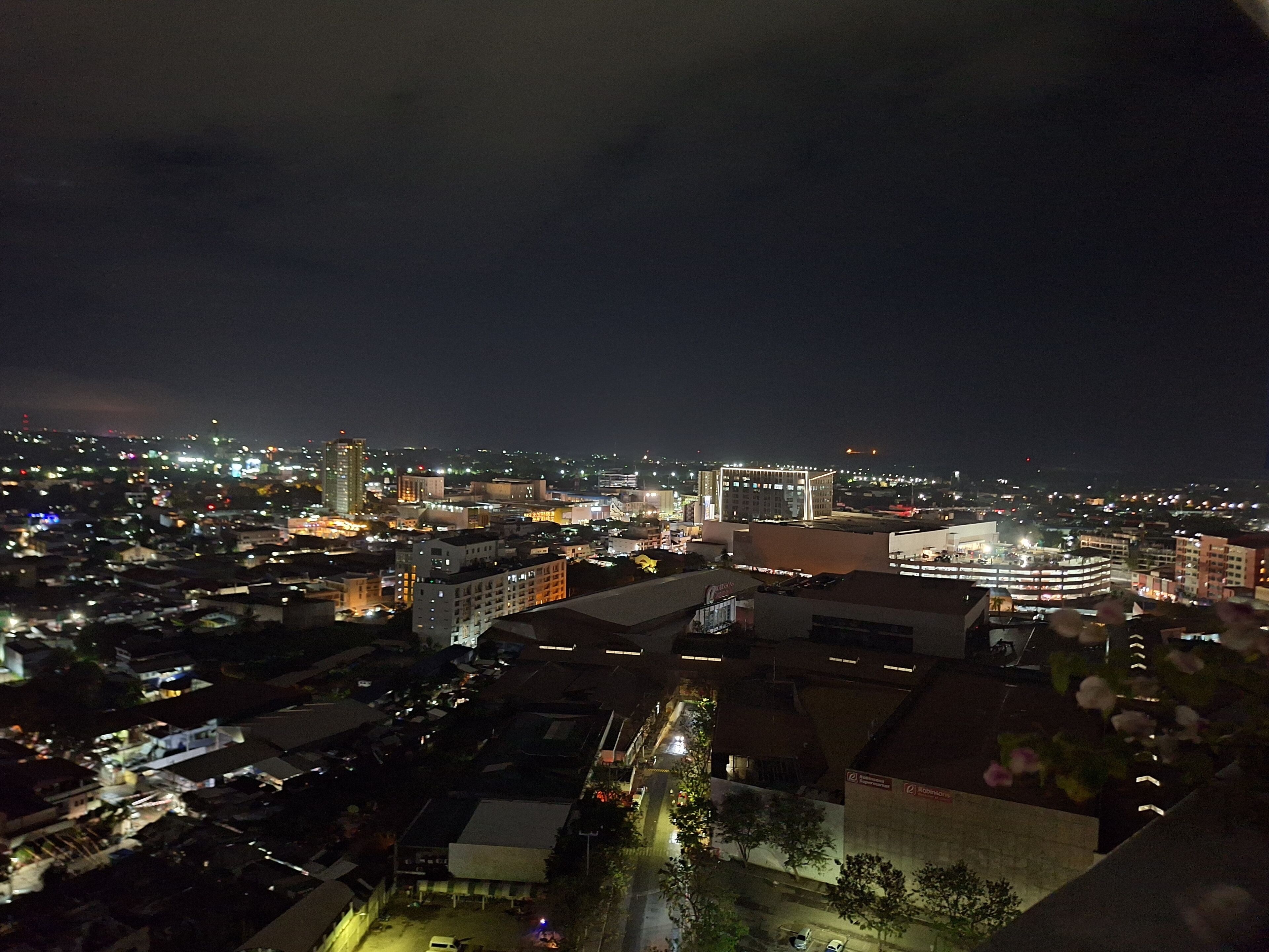 A nighttime cityscape with illuminated buildings and streets.
