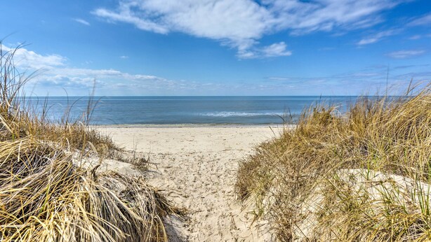 A beach path leading to the ocean with sand and grass on either side. - Cozy Villas Cottage w/ Deck, 1/2 Block to Beach! (Villas)