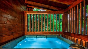 Eine Holzhütte mit Whirlpool.