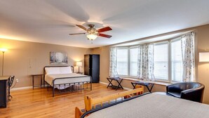 A bedroom with a bed, a desk, a chair, a ceiling fan, and a window with curtains. - ATV Trail Access! Secluded Mountain Retreat (Duff)