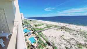 A resort with a pool, beach, and ocean view.