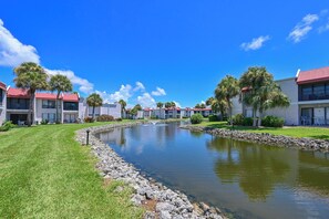A hotel with multiple-story buildings, a central water feature, and well-maintained lawns. - Runaway Bay 128 - Beach, Pool, gym and bay (Bradenton Beach)