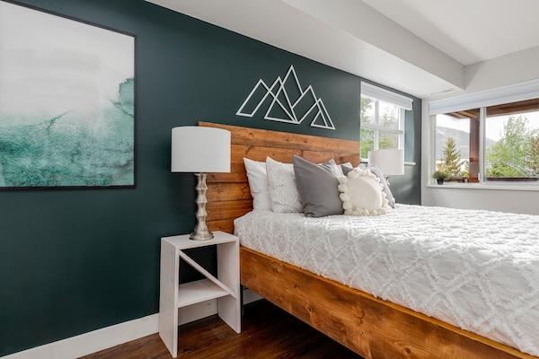 Bedroom - Comfy queen bed, air conditioning, wall-mounted SmartTV with cable channels.
