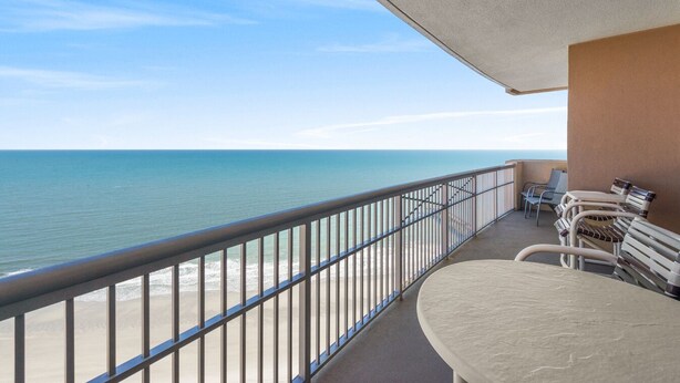 A balcony with a view of the ocean, a table, and chairs. - $150 activities - E-gift card when you book - Upscale Coastal Vibe  | Margate Tower | M2703 (Myrtle Beach)