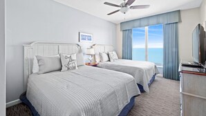 A hotel room with two beds, a ceiling fan, a TV, and a view of the ocean. - $150 activities - E-gift card when you book - Upscale Coastal Vibe  | Margate Tower | M2703 (Myrtle Beach)