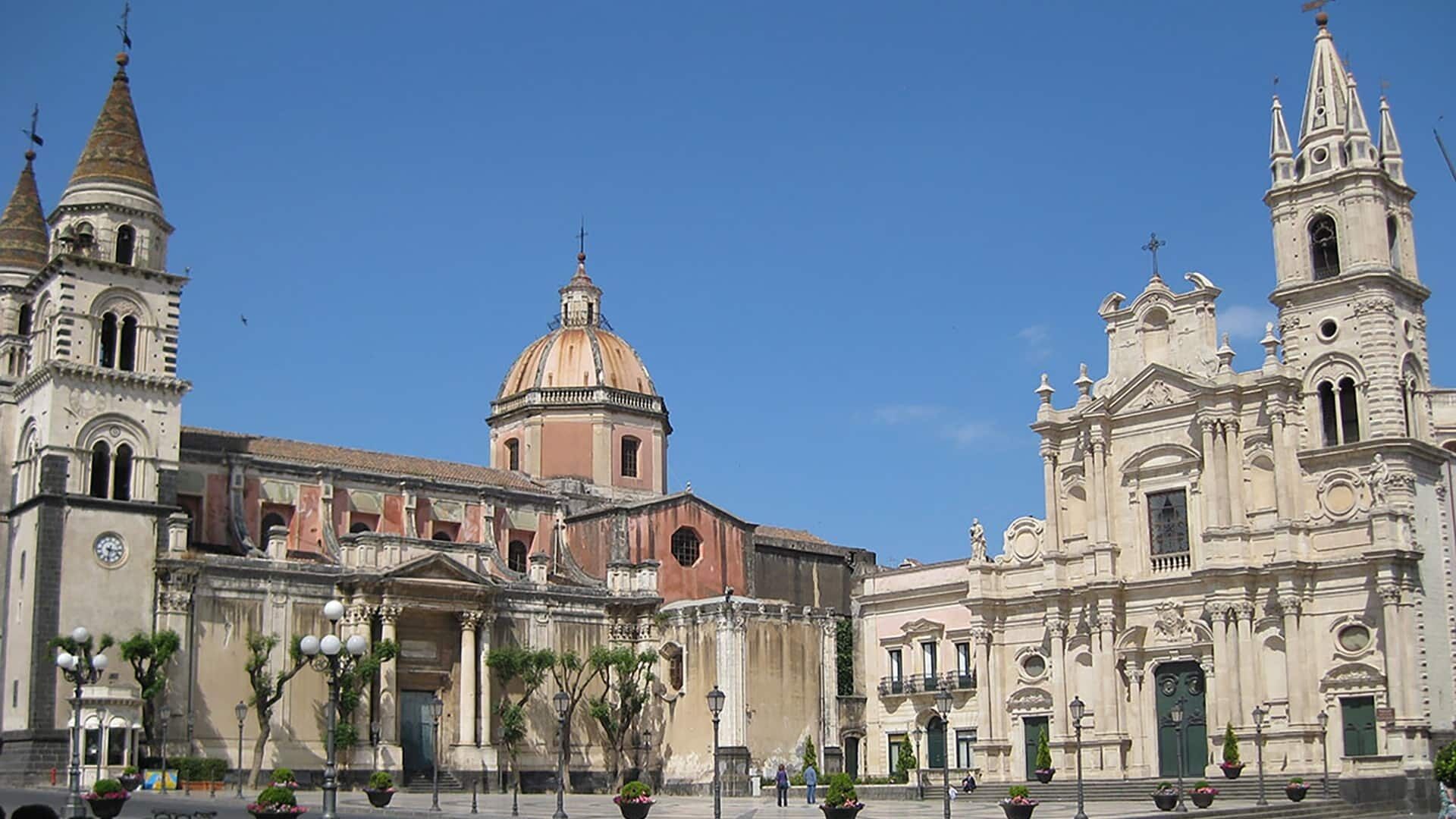 A historic building with a prominent dome, a bell tower, and a facade with columns.