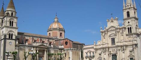A historic building with a prominent dome, a bell tower, and a facade with columns.