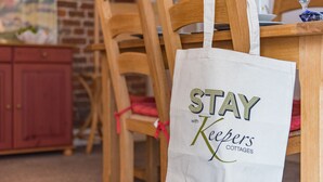 A wooden chair with a white tote bag hanging from the backrest. - Charming holiday  cottage in the centre of Deal, sleeping 6 guests, 2 bathrooms seconds from the sea (Deal)