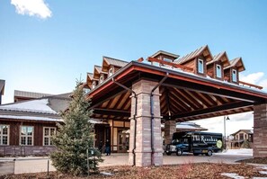 Stylish building with a unique architectural design, featuring a prominent structure and sloped roof.