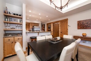 Enjoy meals in the kitchen and dining area, featuring a spacious table and comfortable seating.
