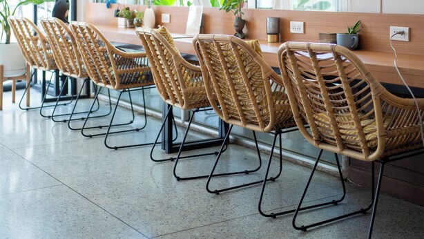 A dining area with wicker chairs, a wooden table, and pendant lights. - Sabai house (Chiang Mai)