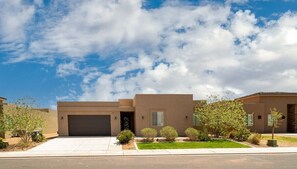 A modern two-story house with a garage, a well-maintained lawn, and a clear sky. - Charlotte: Large Groups + Private Hot Tub + Roof Top Deck (Hurricane)