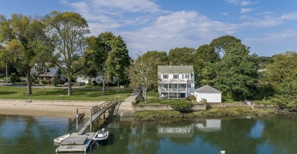 A waterfront property with a dock, a house, and a boat. - Gorgeous Views - Private Beachfront (Salem)