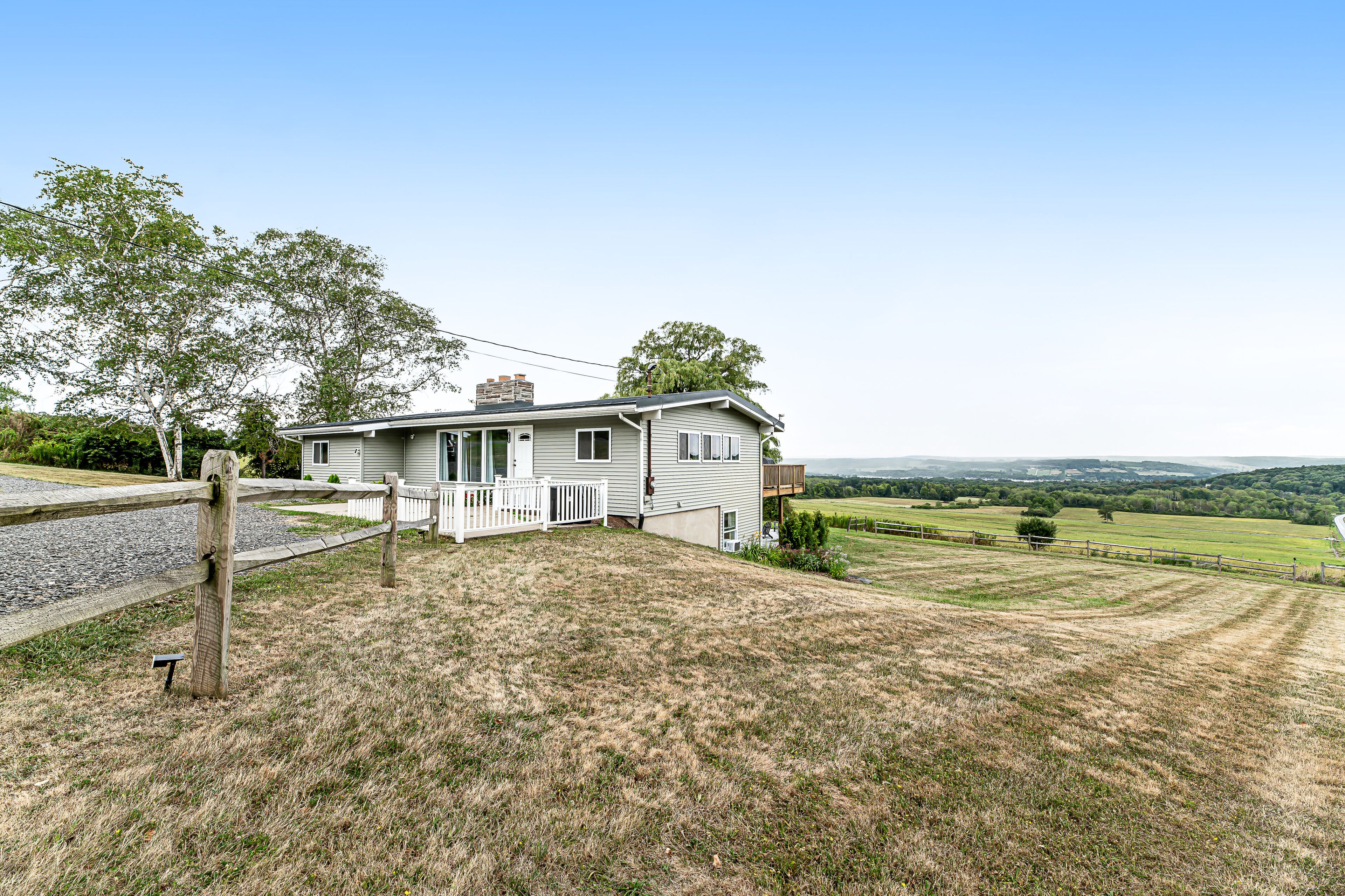 Lake-view countryside haven with deck, two kitchens, fireplace, firepit & AC
