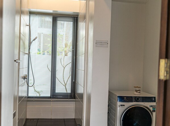 A laundry room with a washing machine, a window with blinds, and a sign indicating laundry usage. - Villa 4 Luxury Private Pool Villa (Langkawi)