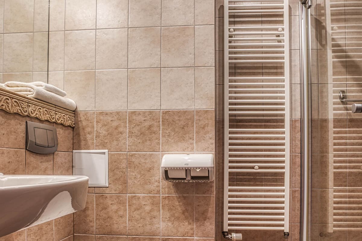 A modern bathroom with a toilet, sink, and shower area.