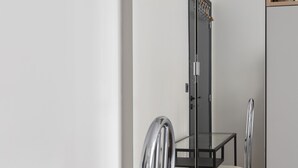 A modern room with a glass table, metal chairs, and a mirrored wardrobe. - Porcelain Pelouse, by Veeve (Paris)