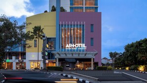 A multi-story hotel with a prominent 'ARTOTEL' sign, a modern architectural design, and a well-lit entrance. - ARTOTEL Grand Prima Surabaya (Surabaya)