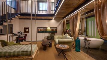 Luxury Studio Suite | Living area | 32-inch flat-screen TV with satellite channels, TV, heated floors