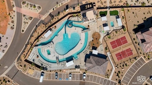 An aerial view of a resort with a central swimming pool, tennis courts, and a parking area. - Deja View by RedAwning (Washington)