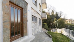 A building with a stone facade, a wooden door, and a stone-paved entrance.