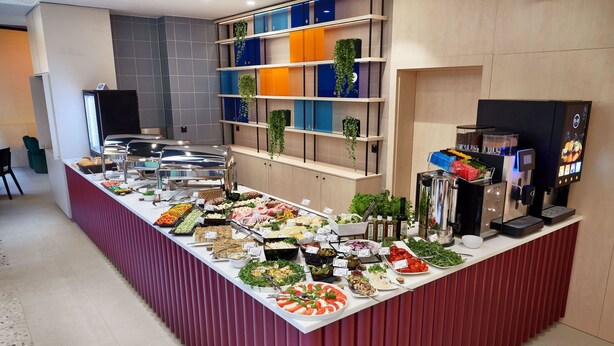 Un buffet proposant une variété de plats et une machine à café.