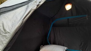 A tent with a sleeping area, including a mattress and a pillow. - Camp Cedar (Baijnath)