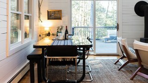 A cozy dining area with a table, chairs, and a rug. - Mossybrook Hideout: Dog Friendly Oasis in High Falls w/ Hot Tub (High Falls)