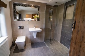 Bathtub, hair dryer, towels, toilet paper