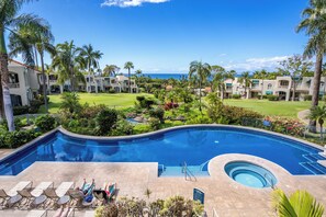 A resort with a swimming pool, lounge chairs, and a view of the ocean. - Palms at Wailea #1605 Tropical Garden View Ground Floor, Wifi, Shared Hot Tub (Wailea)