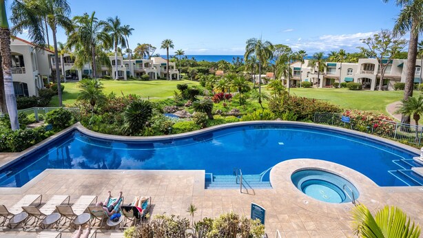 A resort with a swimming pool, lounge chairs, and a view of the ocean. - Palms at Wailea #1605 Tropical Garden View Ground Floor, Wifi, Shared Hot Tub (Wailea)