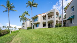 A modern multi-story building with a flat roof, large windows, and balconies. - Palms at Wailea #1605 Tropical Garden View Ground Floor, Wifi, Shared Hot Tub (Wailea)