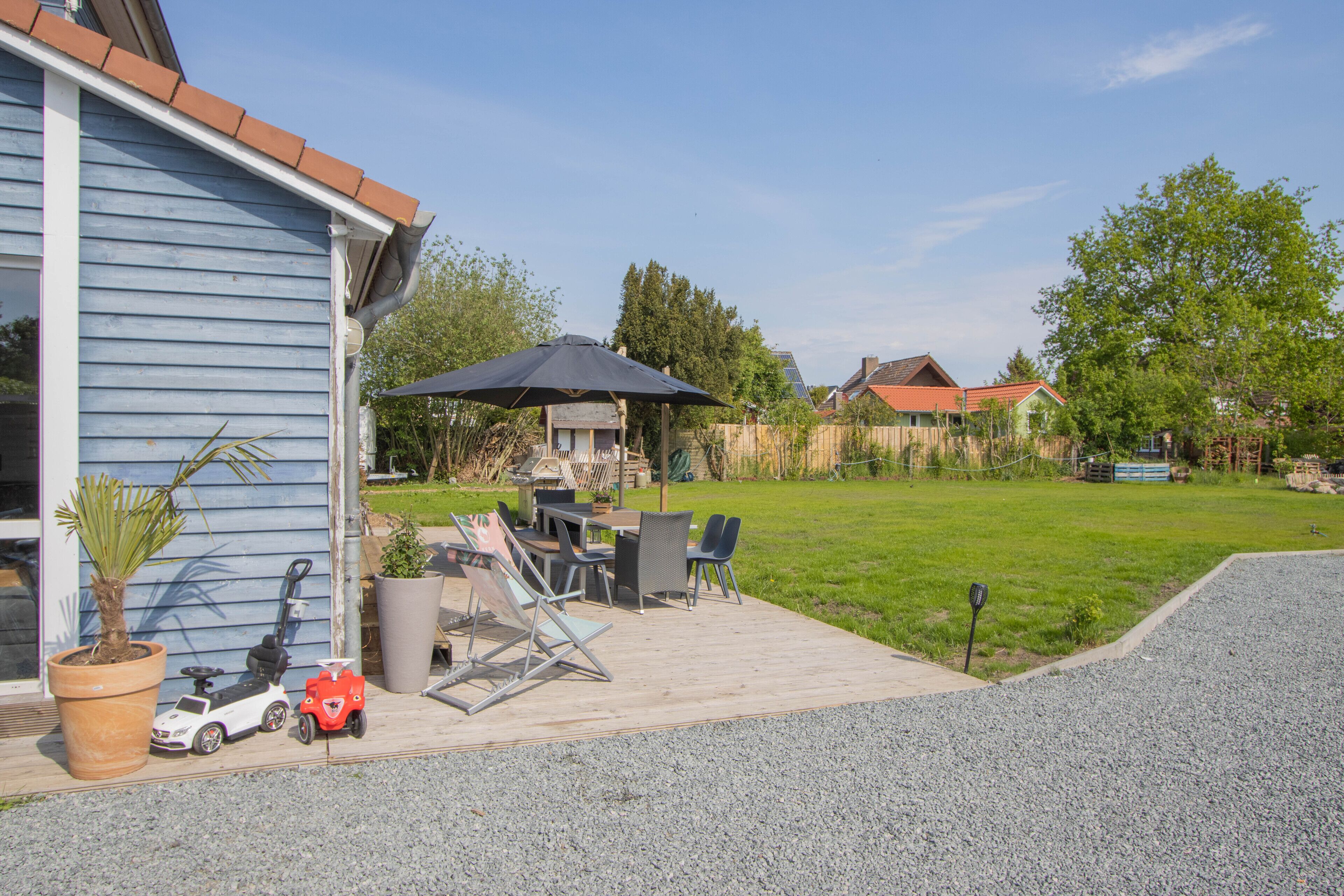 A patio with outdoor furniture, a potted plant, and a toy car.