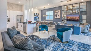 A modern living space with a kitchen, dining area, and seating area.
