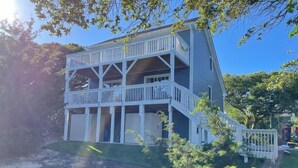 A two-story house with a balcony, a covered porch, and a small deck. - The Gathering Place - 1 Block from Beach! (Emerald Isle)