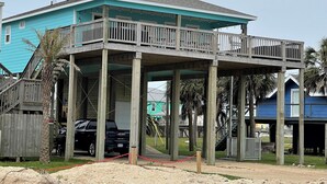 A two-story house with a balcony, wooden deck, and a garage. - Island life, Island time, After Dune Delight (Freeport)