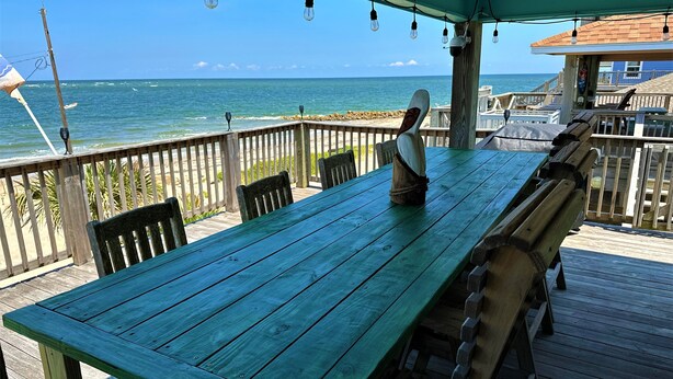 A wooden deck with a table and chairs overlooking the ocean. - Island life, Island time, After Dune Delight (Freeport)