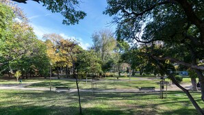 A park with benches, trees, and a clear sky. - Snjezanal- in the Center - A1 (Split)