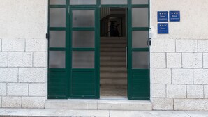 A building entrance with a green door, a staircase leading inside, and two signs indicating 'APARTMAN' with stars. - Snjezanal- in the Center - A1 (Split)