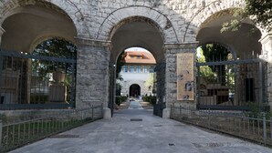 A stone archway leading to a building with a tiled roof. - Snjezanal- in the Center - A1 (Split)