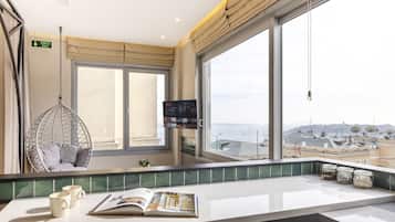 Honeymoon Penthouse, Hot Tub, Partial Sea View | Living area | 42-inch Smart TV with cable channels, TV, Netflix