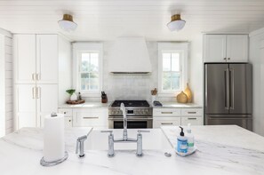 Fridge, dishwasher, coffee/tea maker, cookware/dishes/utensils