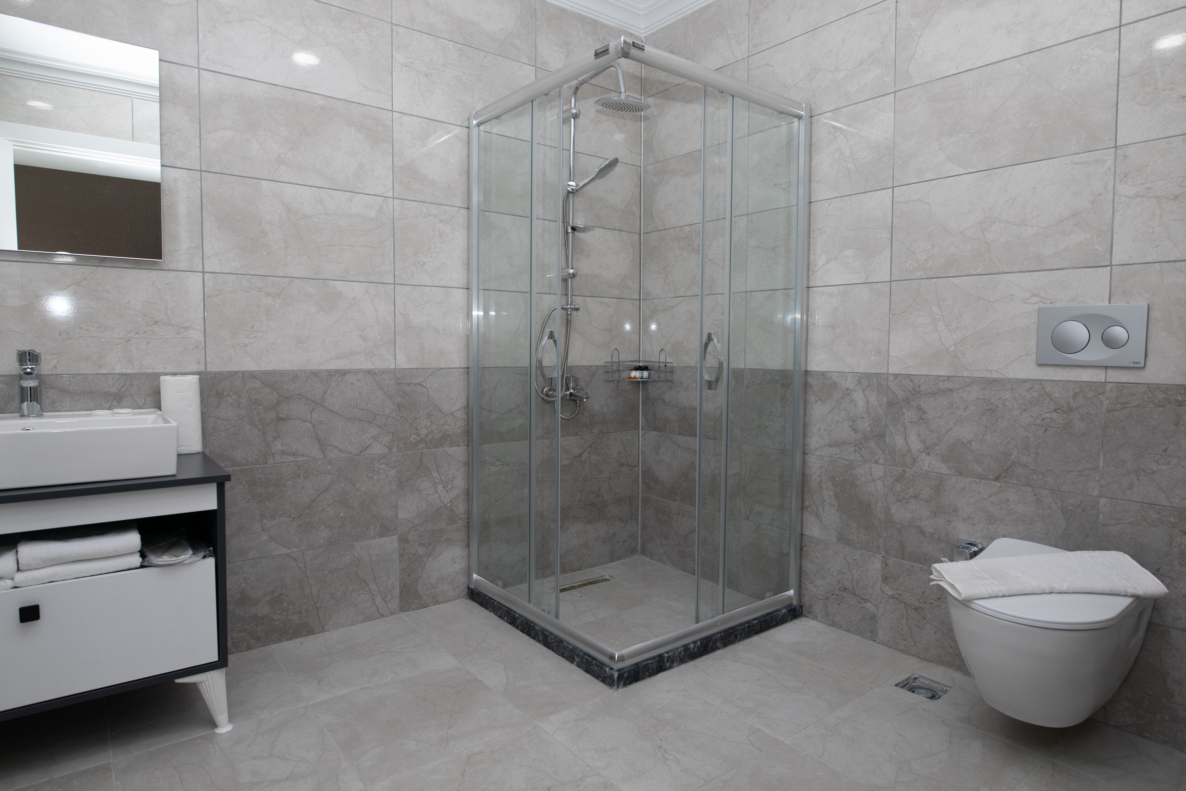 shower, rainfall showerhead, hair dryer, towels