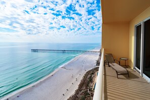 A balcony with a view of a beach and a pier. - 5B’s Beach Break-Beachfront Condo+Beach Chairs🌴2024 - The Year of FUN in the SUN (Panama City Beach)