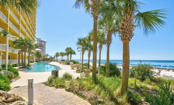 Relax by the pool surrounded by lush palm trees and enjoy stunning ocean views.