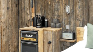 A wooden cabinet with vintage Marshall amplifiers and a radio, a wooden door, and a small wooden shelf with a pillow. - The Retreat, Windermere (windermere)