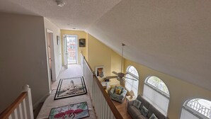 A staircase leading to a living area with a view of the outside. - On canal. 3 minute walk from beach! 5 minutes from everything!! (Ocean Isle Beach)