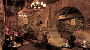 A cozy interior with stone walls, wooden furniture, and a billiards table. - The Oliver Inn | Duluth Hotel Near Canal Park (Duluth)