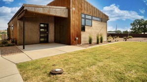 A modern building with a wooden exterior and a large window.