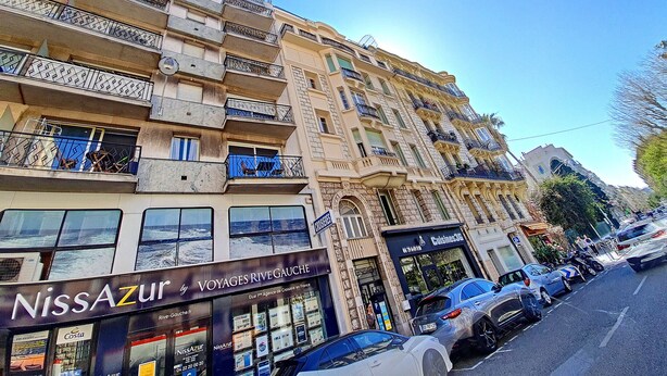 A multi-story building with balconies, a storefront named 'NissAzur', and parked cars on the street. - N&J - FLOREAL BEACH - Central - Close sea  (Niza)